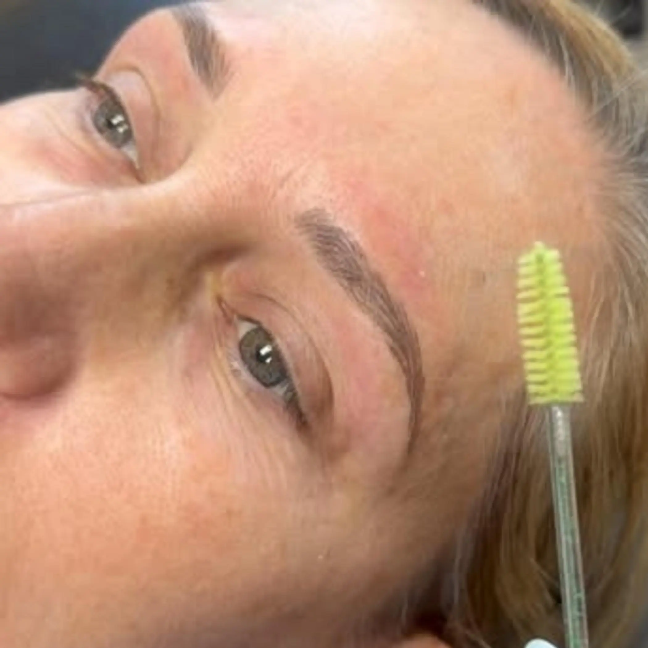 technician applying nano stroke eyebrow technique